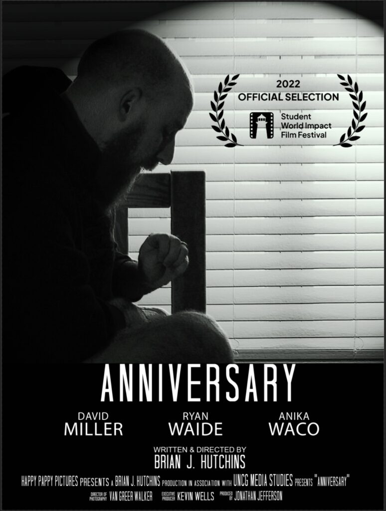 black and white photo of a seated man with a long beard