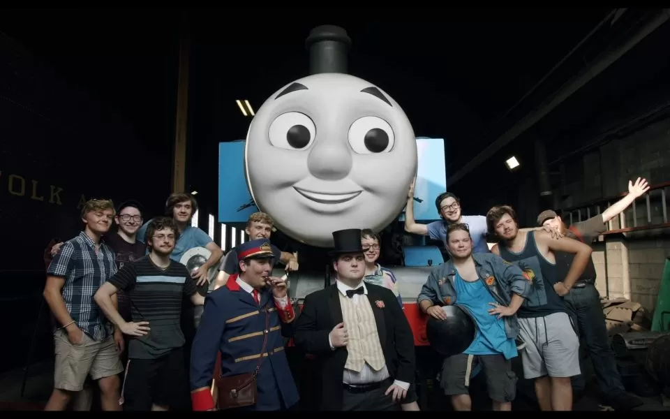 A group of fans, including Brannon Carty, pose with a life-sized Thomas at Strasburg Rail Road in Pennsylvania. (film still)
